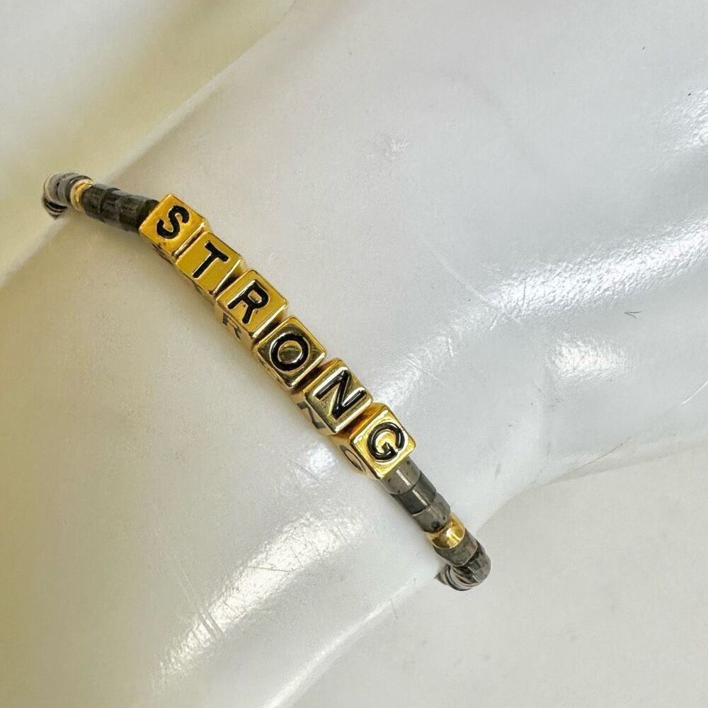 Grey and gold tone STRONG bracelet